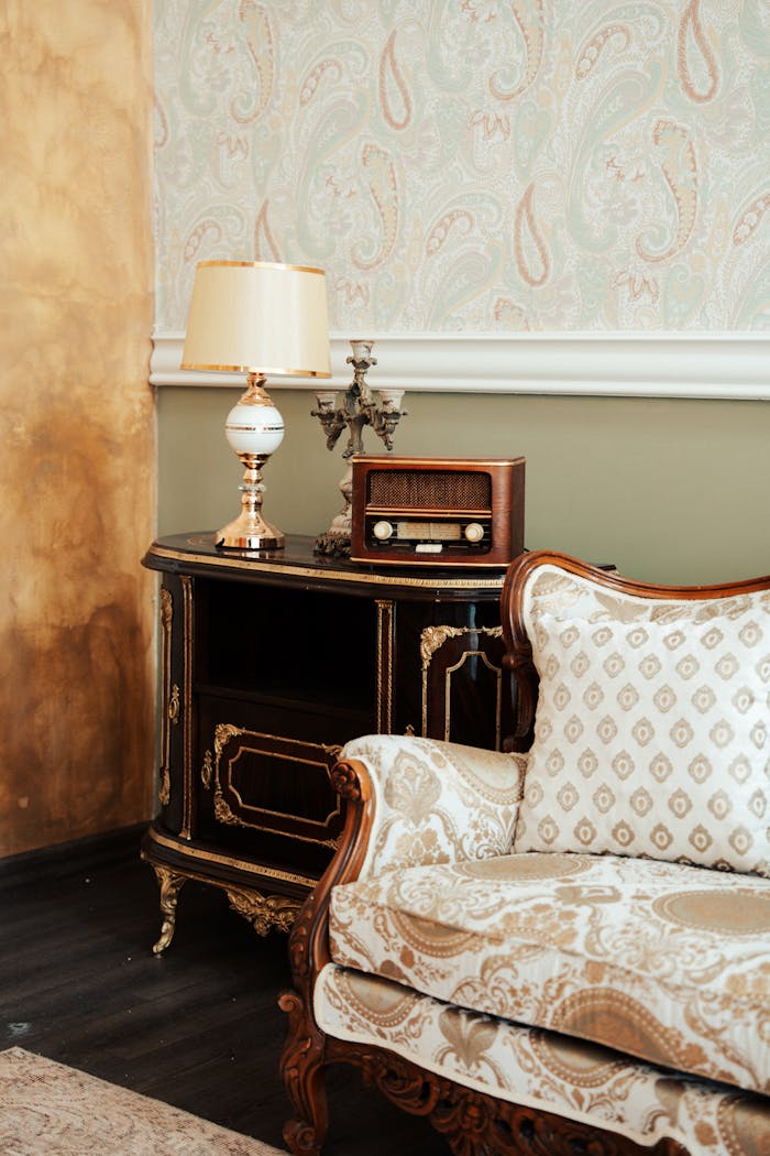 services-03 A classic vintage living room corner featuring an antique radio, lamp, and decorative furniture.